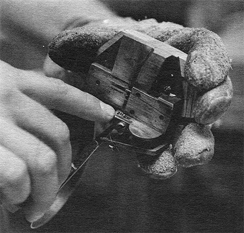 Close-up photograph of Stan Nelson demonstrating a hand mold